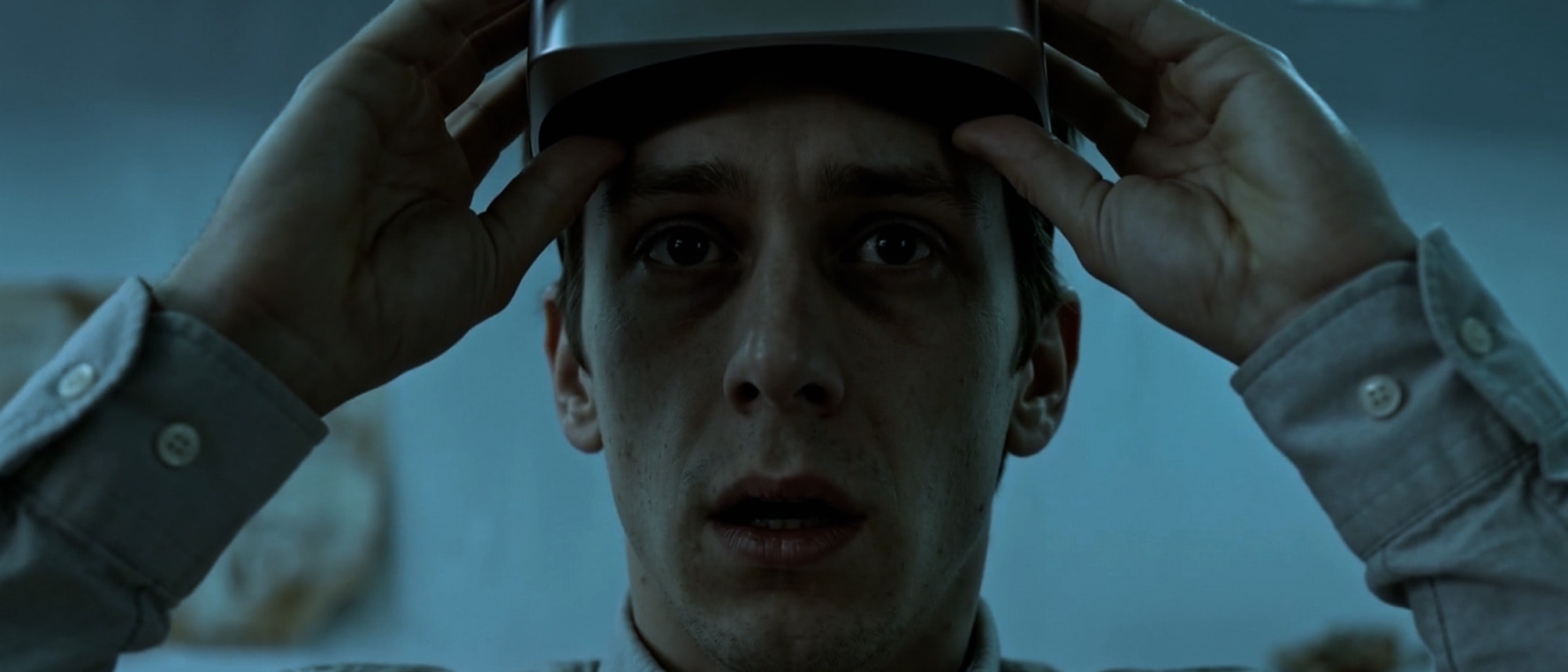 Day two: a cold close-up of the scientist lowering the headset onto his head.
